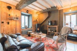 a living room with a couch and a table at Chez Louise in Cauterets