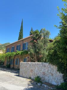 a stone wall in front of a house at Villa Balic in Gruda