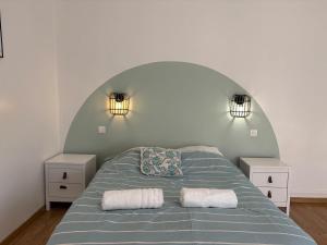 a bedroom with a bed with two white night stands at La Casa Mexico - Terrasse & Parking privé in Trignac