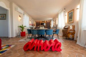 a living room with a table and blue chairs at Apartment In A Villa In The Green Heart Of Umbria in Stroncone