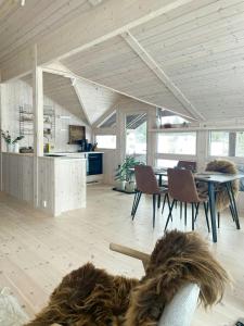 a kitchen and dining room with a table and chairs at Cabin With Views In Langsua National Park in Heggenes