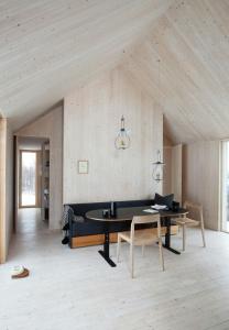 a living room with a table and a couch at Designer Cabin With Mountain Views In Valdres in Ryfoss +22 photos