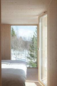 a bedroom with a bed and a large window at Designer Cabin With Mountain Views In Valdres in Ryfoss