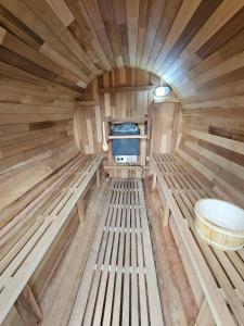 a wooden interior of a sauna with a toilet at Liberty Lakefront Home - Pool, Hot Tub, Sauna in Ferndale
