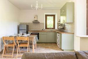 a kitchen with a table and chairs and a kitchen with a sink at Ca'Solare Corticelli in San Cristoforo de Valli