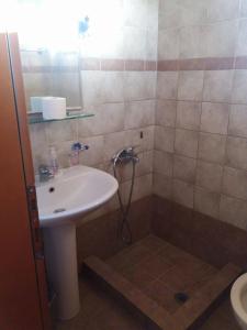 a bathroom with a sink and a shower at Hotel Kosmas in Sarti