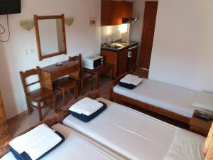 a room with two beds and a desk and a sink at Hotel Kosmas in Sarti +36 photos
