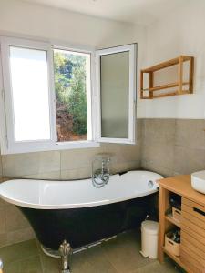 a bath tub in a bathroom with a window at Peaceful Villa Between Saint-Tropez And Verdon in Vidauban