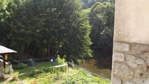 a view of a garden from a window at bord de rivière in Accons