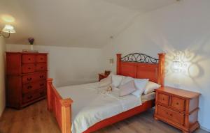 a bedroom with a bed with white sheets and a dresser at Villa Ema - Makarska by Villas Guide in Donji Vinjani +25 photos
