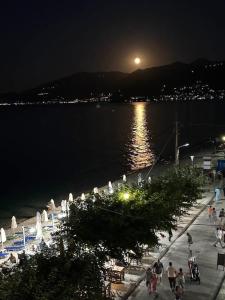 a group of people walking on a pier at night at Seasmiles in Akrata