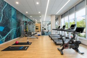 a gym with treadmills and exercise equipment in a room at Hyatt Place National Harbor in National Harbor