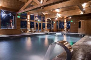 a large swimming pool in a building with at Résidence - Les Grandes Alpes in La Clusaz
