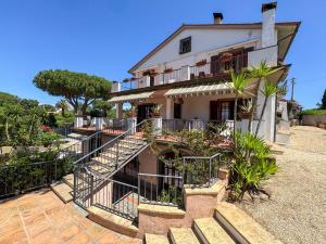 a house with stairs leading up to it at Appartamenti Casa Rossi in Capoliveri