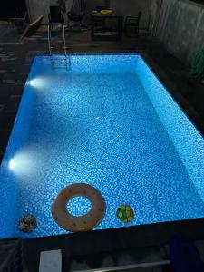 a swimming pool with a donut on top of it at Villa Paradise in Gonio
