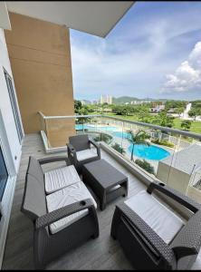 Estación El SaltoにあるHermoso Apartamentoのプールの景色を望むバルコニー(パティオ家具付)