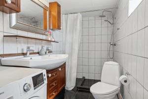a small bathroom with a sink and a toilet at The Cozy Cottage in Hirtshals