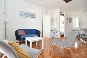 a living room with a blue couch and chairs at Stone & Sea in Budva