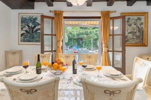 Un comedor con una mesa con copas de vino. en Lovely Villa Las Palmeras, en Marbella