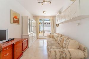 a living room with a couch and a tv at Beautiful Villa La Caracola in Marbella