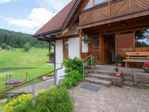 a house with a porch and stairs to the entrance at Ferienwohnung Weiherblick in Hornberg
