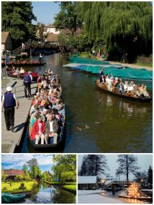 a group of people riding in boats on a river at Wohnung Schlafen im Fass mit Sonnenuntergang Blick in Komptendorf