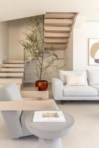 a living room with a couch and a table at Syvana Exquisite Villas in Syvota