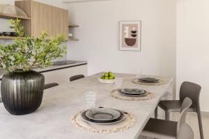a kitchen with a table with plates and a vase at Syvana Exquisite Villas in Syvota