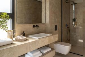 a bathroom with a sink and a toilet and a shower at Syvana Exquisite Villas in Syvota