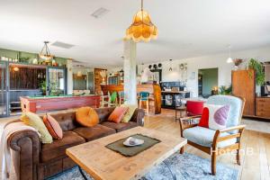 a living room with a couch and a table at Cottage Mamie Yvette Private Spa in Blanc