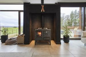 - un salon avec une cheminée et une cuisinière dans l'établissement Sleeper Cottage - Sleeps 8, à Scarborough