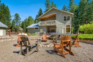 a yard with chairs and a fire pit in front of a house at Cozy Pine Cabin Pool Access in Ronald +58 photos