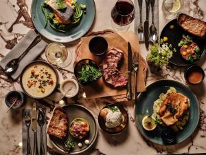 a table with plates of food on it at Radisson Blu Hotel, Hamburg Airport in Hamburg
