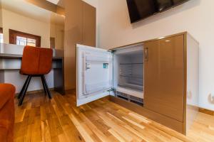 an empty refrigerator in a room with a chair at Old City Lux 2 in Braşov