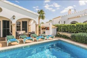 a villa with a swimming pool and a house at Villa Viola Bosch Menorca in Cala'n Bosch