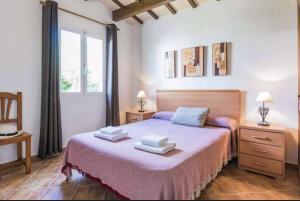 a bedroom with a bed with two towels on it at Villa Viola Bosch Menorca in Cala'n Bosch +18 photos