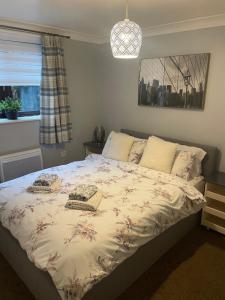 a bedroom with a bed with two baskets on it at Whittlesey town centre apartment in Peterborough