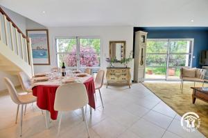 a dining room with a red table and chairs at La maison de chris in Theix