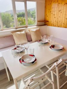 a white table with plates and glasses on it at Welooveyou Wildlife in La Lajita +16 photos
