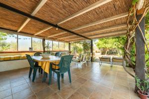 an outdoor patio with a table and chairs at Pretty House in Villamassargia