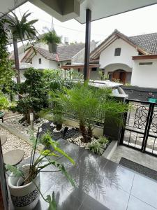 a view of a garden with plants on a balcony at Ndalem Suryo Guesthouse in Yogyakarta
