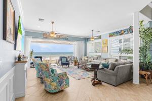 a living room with a view of the ocean at Luxury Beach Front Pool Home in Paradise! home in Fort Myers Beach