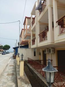 a building with balconies on the side of a street at Hotel Kosmas in Sarti