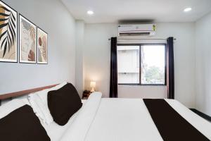 a bedroom with a white bed and a window at Hotel O HNG INN in Guwahati