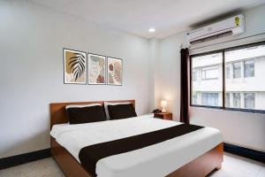 a bedroom with a large bed and a window at Hotel O HNG INN in Guwahati