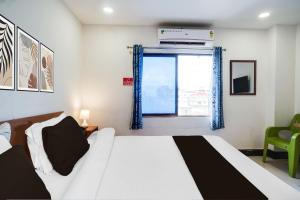 a bedroom with a white bed and a window at Hotel O HNG INN in Guwahati