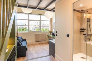 a living room with a shower and a window at Maison Delage in Courbevoie