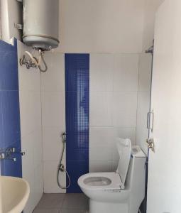 a small bathroom with a toilet and a sink at Jalaram House 2 Kedarnath in Kedārnāth