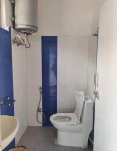 a bathroom with a toilet and a sink at Jalaram House 2 Kedarnath in Kedārnāth