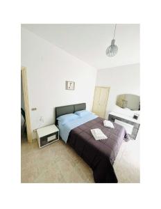 a bedroom with a large bed and a desk at Il Nido in Castelsaraceno